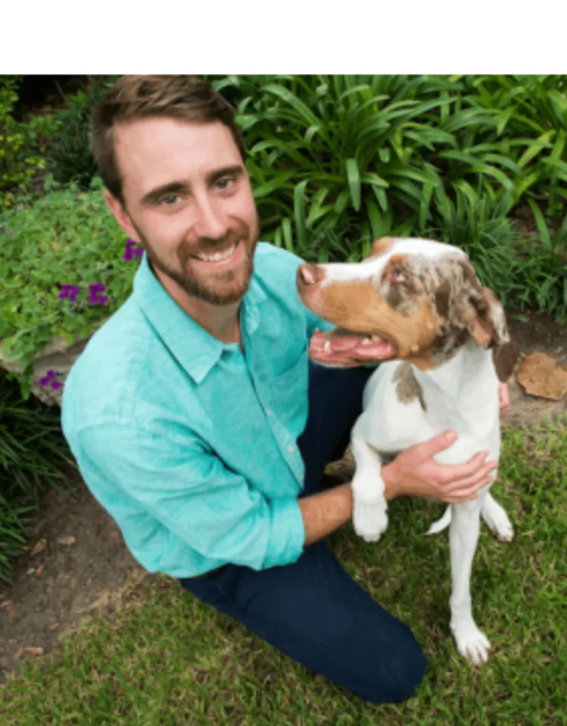 Alex Juneau with a brown/white dog
